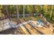 Aerial view of backyard with a stone fire pit and two blue Adirondack chairs surrounded by a wooded perimeter at 1253 Lakefront Dr, Charleston, SC 29412