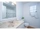 Clean bathroom featuring a marble vanity, decorative mirror, and natural light at 1253 Lakefront Dr, Charleston, SC 29412