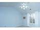 Minimalist bedroom with a ceiling fan, a window, and pale blue walls at 1253 Lakefront Dr, Charleston, SC 29412