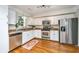 Efficient kitchen with stainless steel appliances, white cabinets, and hardwood floors at 1253 Lakefront Dr, Charleston, SC 29412