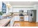 Well-lit kitchen with stainless steel appliances and a double basin sink and hardwood floors at 1253 Lakefront Dr, Charleston, SC 29412