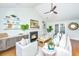 Bright living room with vaulted ceilings, fireplace, and a ceiling fan, decorated with plants and modern furniture at 1253 Lakefront Dr, Charleston, SC 29412