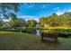 Serene pond view from a bench amidst lush trees under a vibrant sky, offering a peaceful retreat at 1253 Lakefront Dr, Charleston, SC 29412