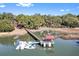 Stunning aerial view of a waterfront property with a private dock and boat lift at 127 Oak St, McClellanville, SC 29458