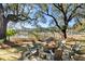 Charming backyard fire pit with chairs and waterfront view beyond at 127 Oak St, McClellanville, SC 29458