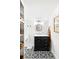 Charming bathroom featuring black vanity with marble countertop and decorative tile floor at 127 Oak St, McClellanville, SC 29458