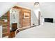 Bedroom with vaulted ceilings, a plush bed, stylish furnishings, and ensuite bathroom behind a wood partition at 127 Oak St, McClellanville, SC 29458