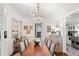 Elegant dining room features a wood table, chandelier, bar cart, and opens to a modern kitchen at 127 Oak St, McClellanville, SC 29458