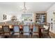 Stunning dining room features a wood table, hutch, and opens to a bright kitchen at 127 Oak St, McClellanville, SC 29458