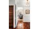 Dining room with a chandelier and seating for six, as seen from the hallway with hardwood floors at 127 Oak St, McClellanville, SC 29458