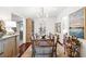 Bright dining room features a wood table, chandelier, and view to the kitchen at 127 Oak St, McClellanville, SC 29458