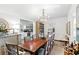 Spacious dining room features a wood table, chandelier, and opens to a bright kitchen at 127 Oak St, McClellanville, SC 29458