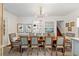Inviting dining room with a wood table and seating, art, and view to the kitchen at 127 Oak St, McClellanville, SC 29458