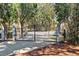 View of the property gate that offers privacy and security, framed by mature trees and lush landscaping at 127 Oak St, McClellanville, SC 29458
