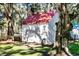 Small outbuilding with a red roof surrounded by beautiful trees at 127 Oak St, McClellanville, SC 29458
