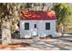 Quaint shed with a red roof, a door, two windows, and bikes nearby at 127 Oak St, McClellanville, SC 29458