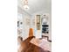 Hallway showcasing hardwood floors with doorways leading to a closet, bedroom, and office space at 127 Oak St, McClellanville, SC 29458