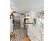 Charming kitchen features stainless steel appliances, farm sink, and patterned tile flooring at 127 Oak St, McClellanville, SC 29458
