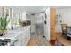 Bright kitchen featuring stainless steel appliances, a farm sink, and views into the dining room at 127 Oak St, McClellanville, SC 29458
