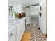 Bright kitchen featuring stainless steel appliances, farm sink, and decorative patterned tile floor at 127 Oak St, McClellanville, SC 29458