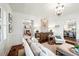 Open living room with views to the dining room, neutral sofa, and decor at 127 Oak St, McClellanville, SC 29458