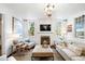 Bright living room with fireplace and TV, neutral sofa, and decor at 127 Oak St, McClellanville, SC 29458