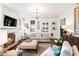 Bright living room features a fireplace, white walls, and elegant chandelier lighting at 127 Oak St, McClellanville, SC 29458