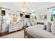 Bright main bedroom with fireplace, detailed dresser, and large windows creating a relaxing and airy atmosphere at 127 Oak St, McClellanville, SC 29458