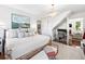 Spacious main bedroom features a cozy sitting area, desk, and decorous chandelier, offering a multi-functional space at 127 Oak St, McClellanville, SC 29458