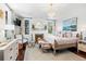 Serene main bedroom featuring a fireplace, chandelier, sitting area, and large painting for a tranquil retreat at 127 Oak St, McClellanville, SC 29458