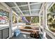 Inviting screened porch with seating, offering a relaxing outdoor space at 127 Oak St, McClellanville, SC 29458