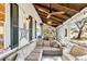 Bright and airy screened porch features ceiling fans and outdoor furniture at 127 Oak St, McClellanville, SC 29458