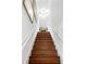 Stairway features hardwood steps, white risers and stringers leading to a well-lit upper level at 127 Oak St, McClellanville, SC 29458