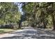 Charming street lined with majestic live oak trees draped in Spanish moss at 127 Oak St, McClellanville, SC 29458