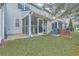 Home's backyard offers a screened-in porch area and small yard with side area at 128 Hornby Cir, Goose Creek, SC 29445