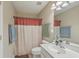 Bathroom showcases a clean vanity, toilet, and shower with colorful curtains at 128 Hornby Cir, Goose Creek, SC 29445