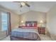 Cozy bedroom featuring a ceiling fan, bedside tables with lamps, and a large window at 128 Hornby Cir, Goose Creek, SC 29445
