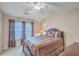 Bedroom featuring a ceiling fan, bedside table with lamp, and a large window with curtains at 128 Hornby Cir, Goose Creek, SC 29445