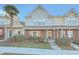 Charming two-story townhome with brick accents, complemented by a sidewalk and lush green lawn at 128 Hornby Cir, Goose Creek, SC 29445