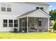 Relaxing screened-in back porch with outdoor seating, overlooking a lush green lawn at 133 Threaded Fern St, Summerville, SC 29485
