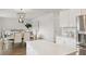 Open-concept living and dining area with a view to the kitchen, chandelier, and stainless appliances at 133 Threaded Fern St, Summerville, SC 29485