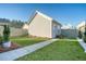 Landscaped backyard with green grass, stone path, and privacy fence at 142 Midtown Ave, Summerville, SC 29486