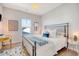 Bright bedroom featuring a black metal bed, white bedding, nautical decorations and natural light from a window at 142 Midtown Ave, Summerville, SC 29486