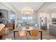 Open dining area featuring a concrete table, seating, and adjacent kitchen with stainless steel appliances at 142 Midtown Ave, Summerville, SC 29486