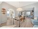 Bright dining room with modern light fixtures, wood floors, and access to living areas at 142 Midtown Ave, Summerville, SC 29486