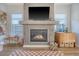 Cozy living room fireplace with a large television above and decor, and a checkered rug at 142 Midtown Ave, Summerville, SC 29486