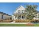 Charming two-story house with a covered front porch, columns, and mature landscaping at 142 Midtown Ave, Summerville, SC 29486