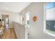 Well-lit upstairs hallway features hardwood floors, sconces, and natural light from windows at 142 Midtown Ave, Summerville, SC 29486