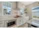 Modern kitchen with white cabinets, stainless steel microwave, and herringbone backsplash at 142 Midtown Ave, Summerville, SC 29486