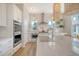 Gourmet kitchen featuring white cabinets, stainless steel oven, large island with sink, and modern appliances at 142 Midtown Ave, Summerville, SC 29486